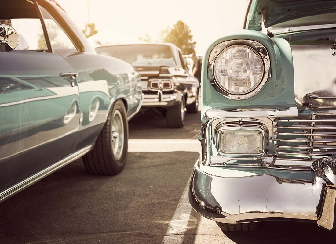 Classic Car Insurance - Close-up of Vintage Cars in a Parking Lot on Display at a Car Show at Dusk